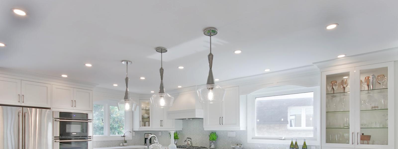 Hanging pendant lights and can lights in kitchen