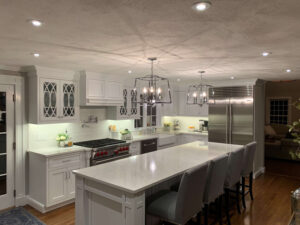 Kitchen with can lights, under-cabinet lights and hanging lights over island